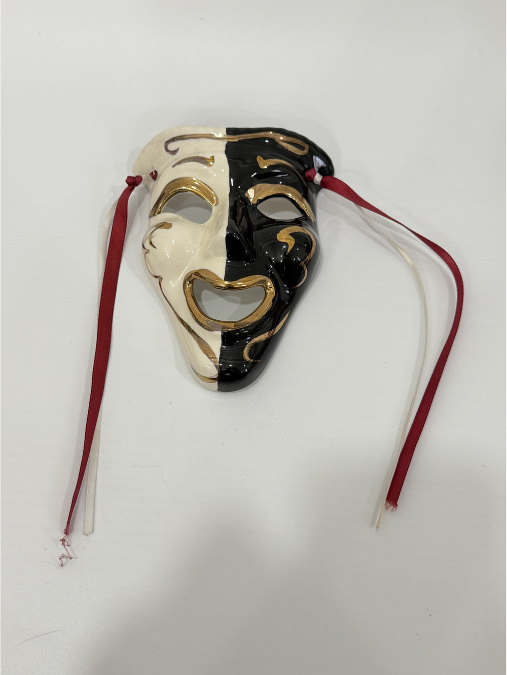 Vintage glass or porcelain Black and white masks with gold accents with ribbon